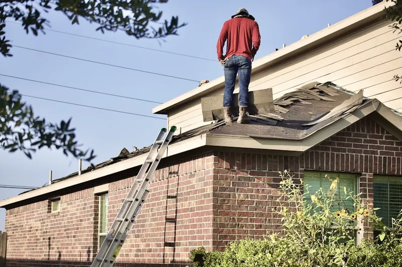 Professional roofer working on a residential roof in Catharpin